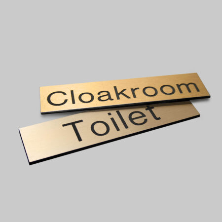 Engraved Sign with adhesive backing - 140x35mm dia Black text on brass effect