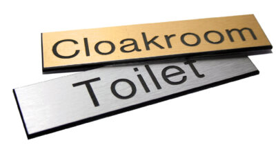Engraved Sign with adhesive backing - 100x75mm dia Black text on brass effect